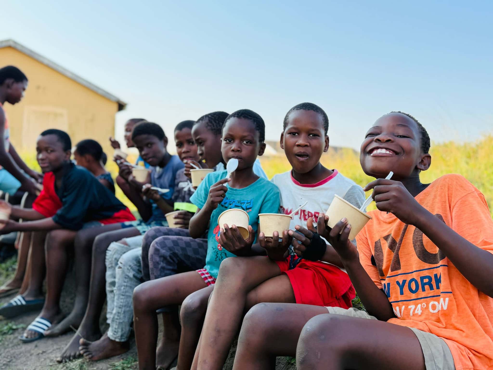 Children smiling as they eat a Big Five Foods meal